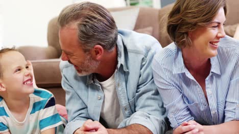 Happy-family-in-lying-on-rug-in-living-room