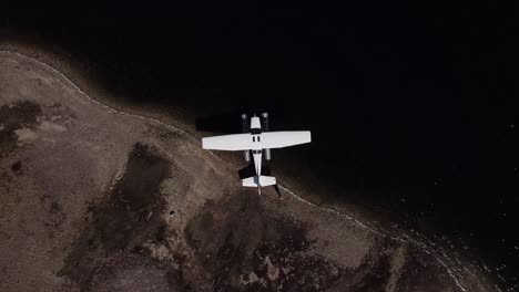 Aerial-Top-Down-Dolly-Out-Above-Seaplane-Moored-at-Lake-Shoreline