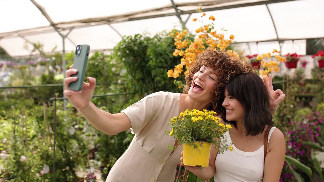 Customers taking selfies with flowers in greenhouse