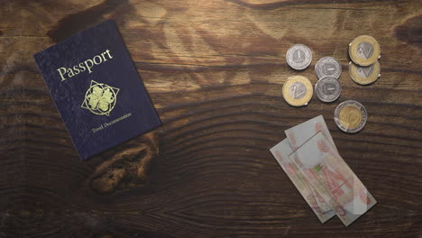 essential travel elements: passport, coins, and bills on a wooden table