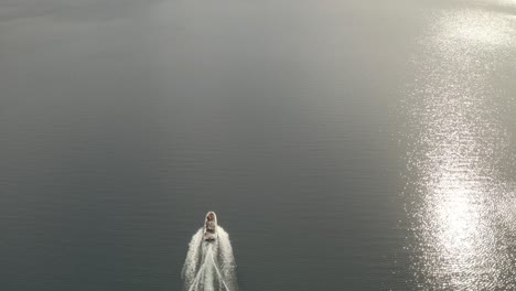 slow motion aerial shot of a boat navigating in lacar lake and revealing the landscape