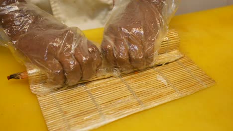 sushi chef preparing sushi rolls