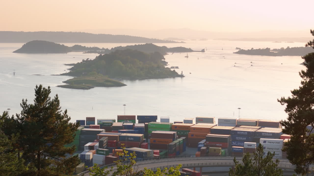 Stacked containers at shipyard of Yilport Oslo, Ekebergparken sunset aerial view