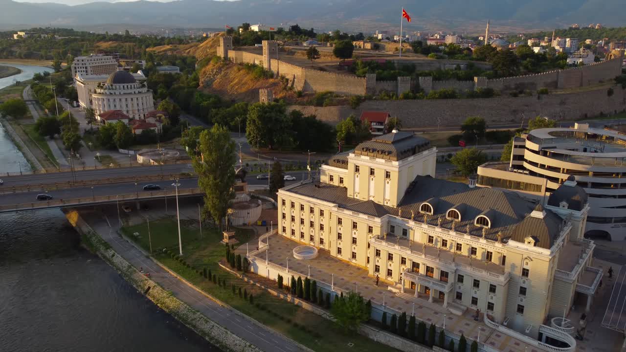 Skopje drone video over Vardar river with National Theatre and Kale Fortress with Macedonian Flag - Skopje, Macedonia