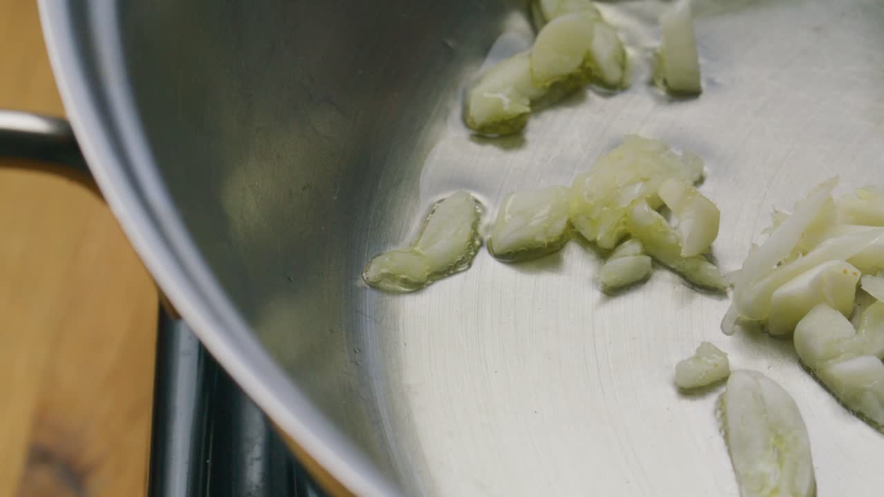 Minced Garlic Being Fried in Olive Oil in Cooking Pan
