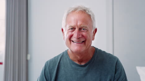 Portrait-Of-Senior-Man-At-Home-Laughing-And-Smiling-At-Camera