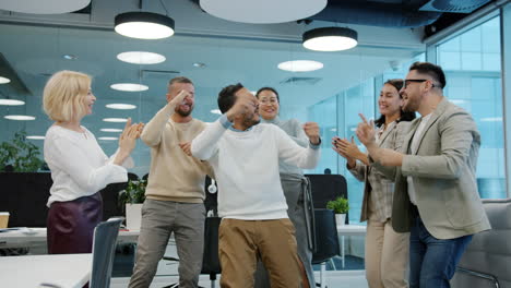 happy office team celebrating