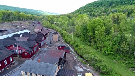 an aerial view of an abandoned narrow gauge coal rail road round house and turntable and support building starting to be restored