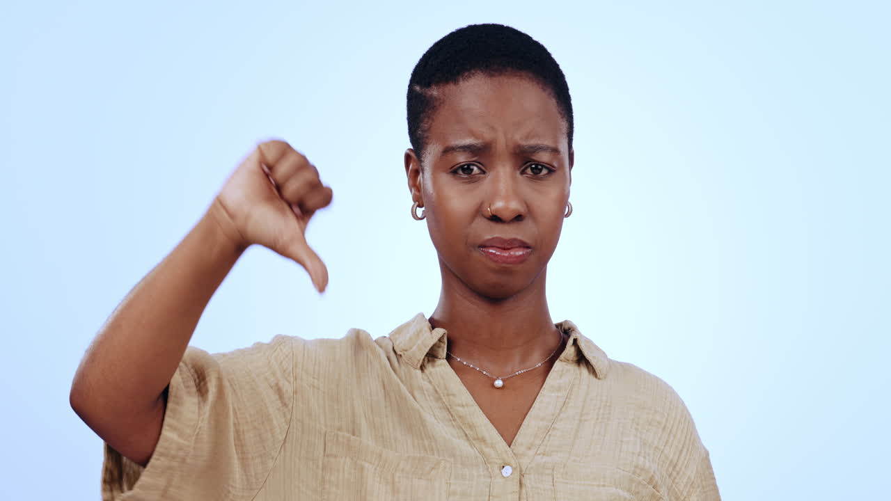 Face, thumbs down and studio black woman