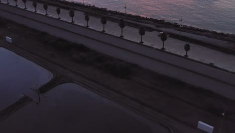 drone flight above sewage treatment pools on the black sea coast at colourful sunset, batumi, georgia