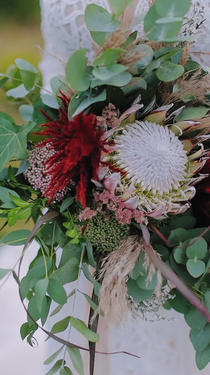 Bride holding wedding bouquet. Bride in dress standing on mountain and holding a bouquet