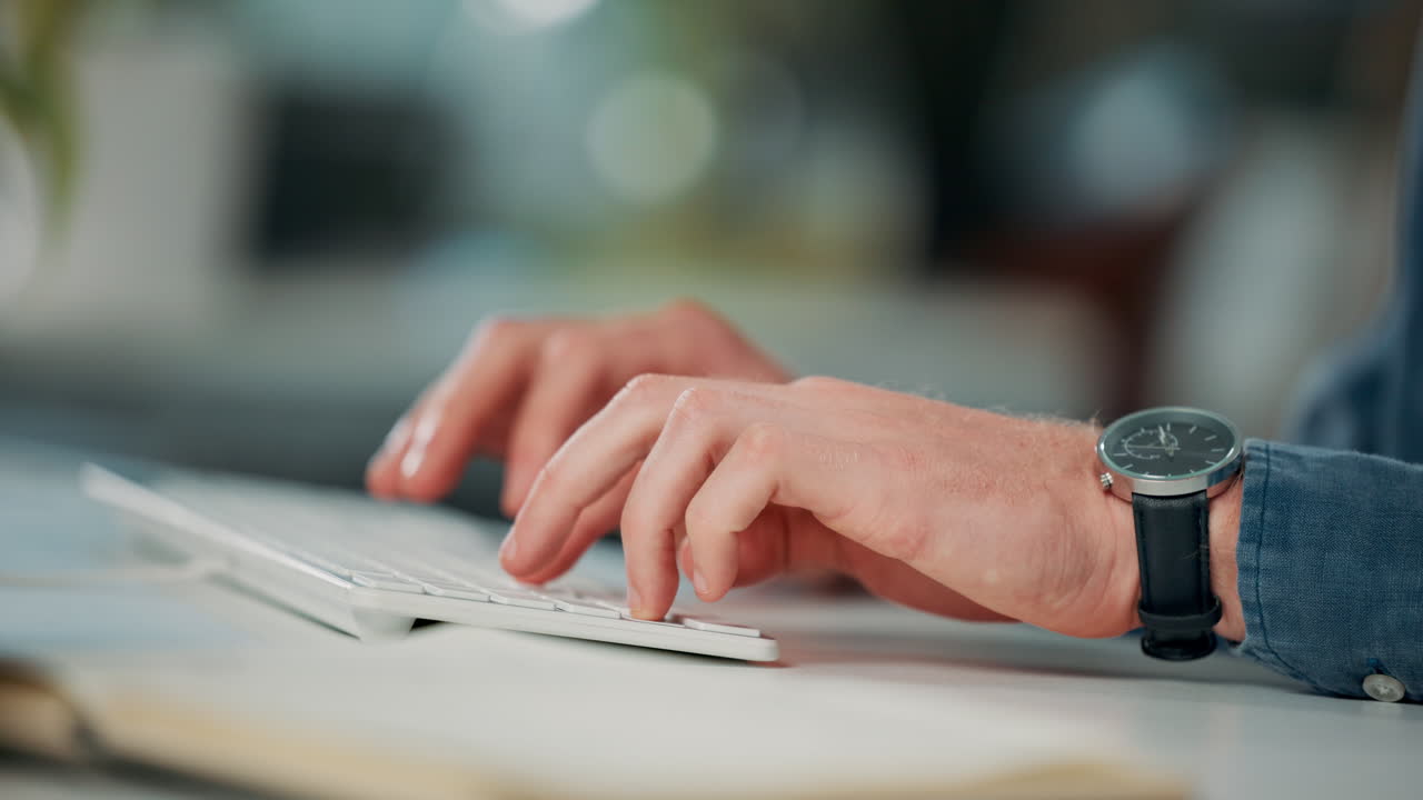 Close-up of hands typing on a keyboard
