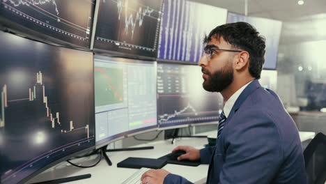 a stock trader analyzes charts and data in a busy office.