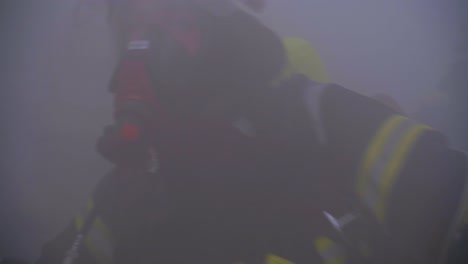 close-up-of-fireman-with-respirator-in-smokey-room