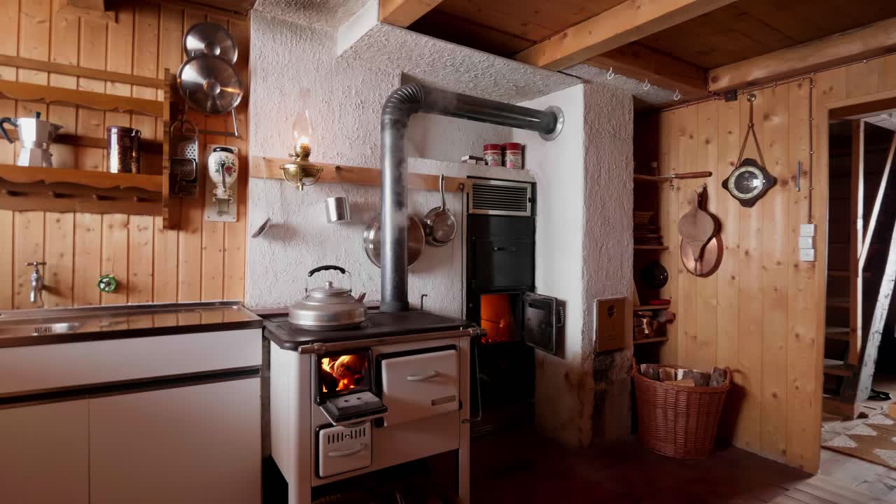 Rustic Swiss kitchen with a wood-burning stove and vintage decor
