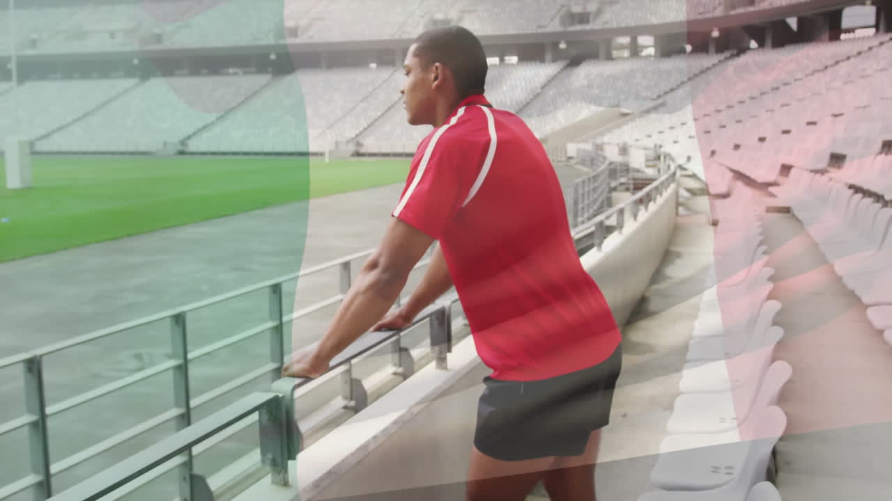 Animation of flag of italy over afrcian american rugby player in stadium