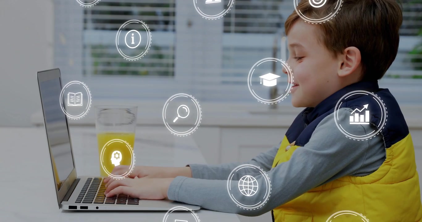 Ragazzo che inizia a digitare sul laptop al tavolo, osservando icone educative che appaiono e poi scompaiono