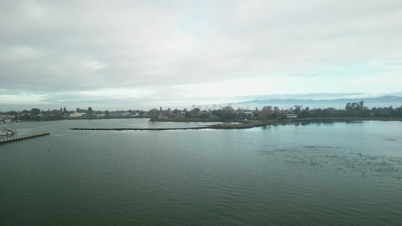 캘리포니아의 알라메다에 있는 크래브 코브 (crab cove) 의 공중 촬영으로, 활기찬 초록색과 반이는 물과 모래 해변이 여 있습니다.