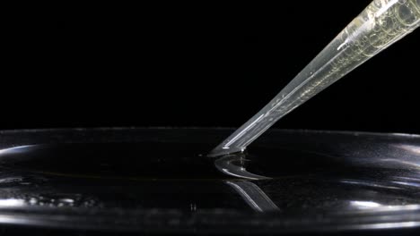 sucking up light oil and water with a pipette - heterogeneous mixture - macro, slow motion