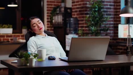 tired businesswoman looking at watch, annoyed by time passing too slow