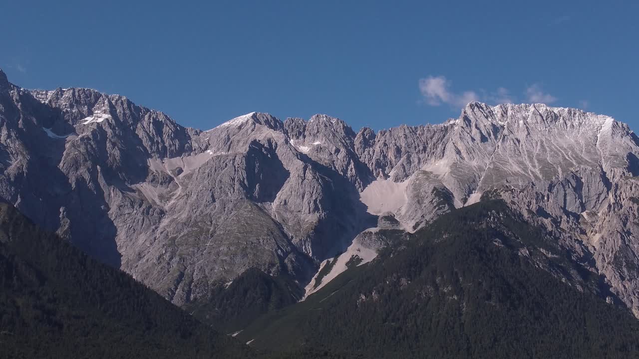 Close up Drone view on a massive mountain side in the austrian alps while it's descending downwards to land