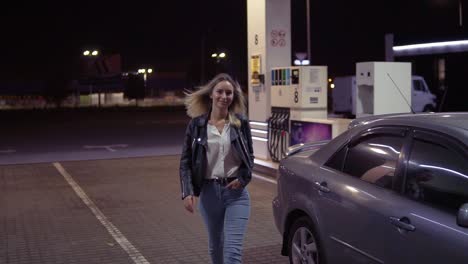 Portrait-Of-Romantic,-Smiling-Woman-At-The-Gas-Station-In-Caual,-The-Car-In-The-Background-Walks-And-Posing