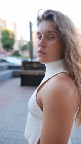 teenage girl in white outfit on city street