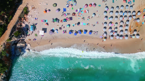 Drone-Aéreo-De-Arriba-Hacia-Abajo-Filmado-Sobre-Agua-Clara-Y-Turquesa-Del-Mar-Jónico-Con-Olas-Rompiendo-A-Lo-Largo-De-La-Playa-De-Gjipe,-Albania-En-Un-Día-Soleado