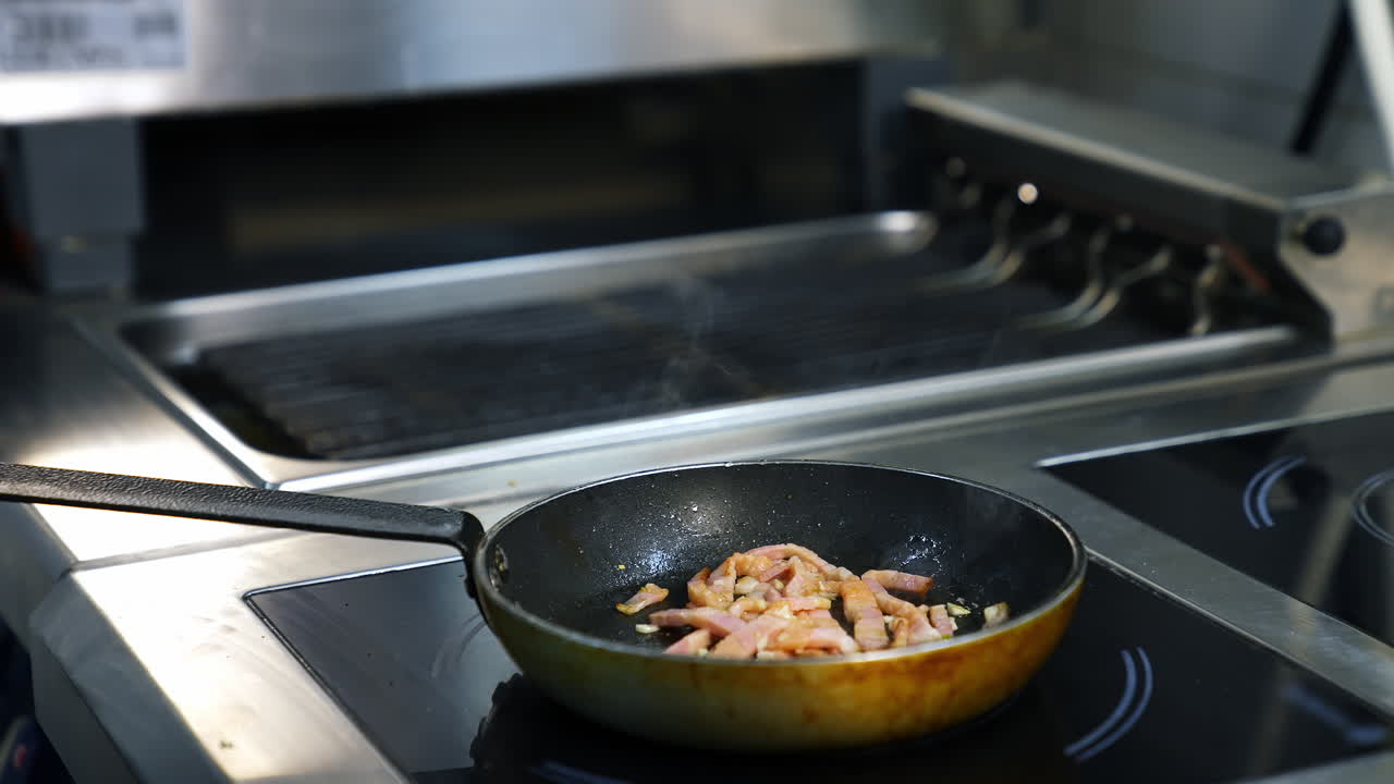 Chef preparing food in restaurant. Hands of chef cooking food in frying pan