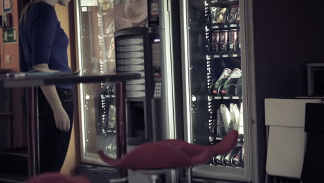 woman using coffee vending machine