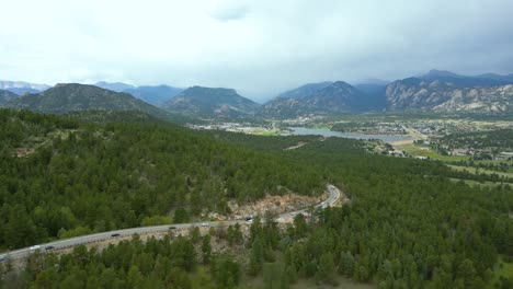 Aerial-View-Of-Asphalt-Road-Through-Pine-Forest-In-Estes-Park,-Colorado,-USA