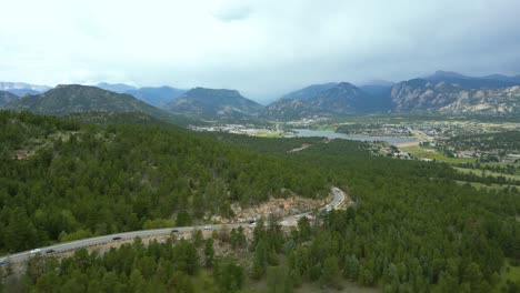 aerial view of asphalt road through pine forest in estes park, colorado, usa