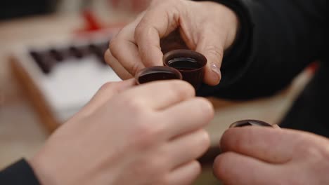 cheers with ginjinha in chocolate cups, portugal