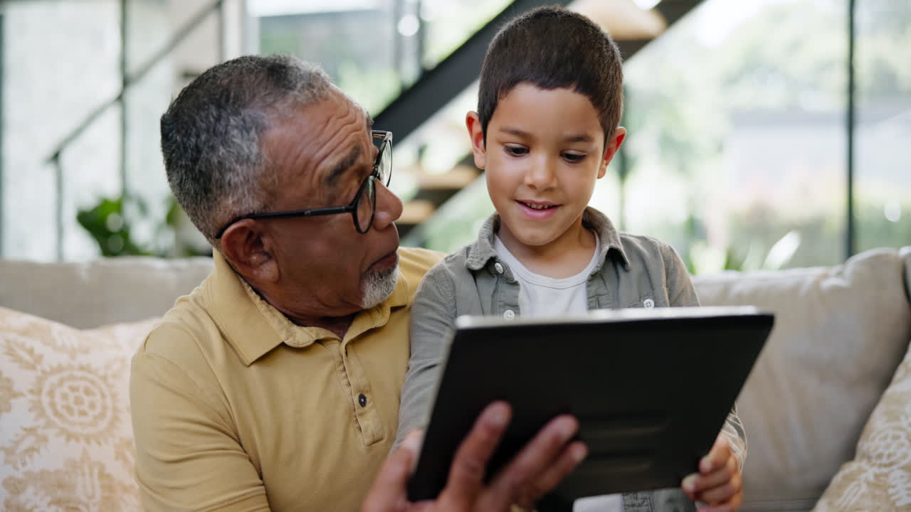 Grandfather and Grandson Using Tablet Together