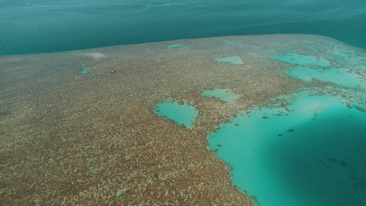 Aerial Shot for the Red Sea of Egypt in the North beside Hurghada with the drone moving forward towards a light house on a coral island of Abu Nuhas Coral island