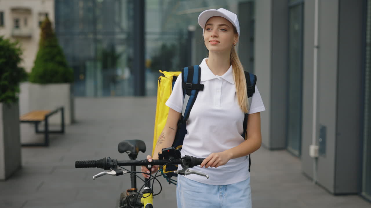 Delivery Person with Bicycle in Front of Modern Building
