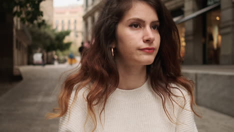 Bored-woman-looking-at-her-smartphone-in-the-city