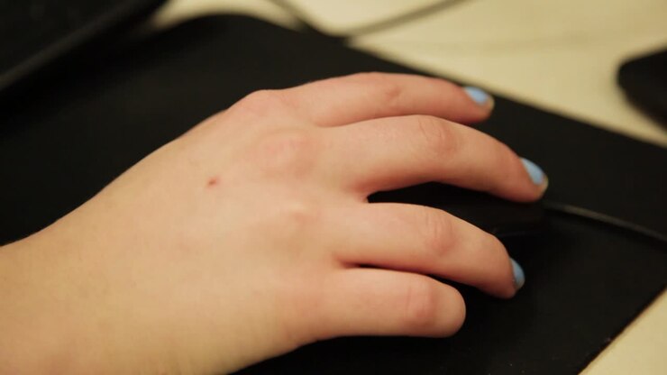 Student's Hand Scrolling with a Computer Mouse