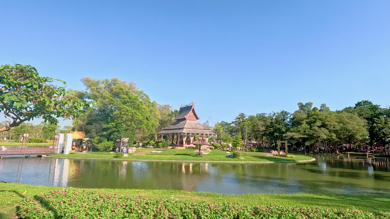 A tranquil pavilion by a pond in Rama IX Park, Bangkok, captured under ...