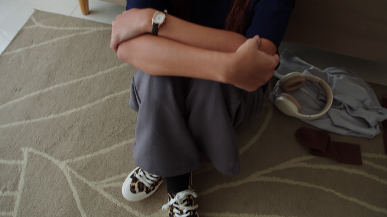 Sad woman sitting on the carpet