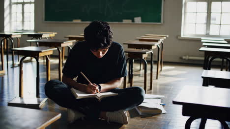 student studying in empty classroom