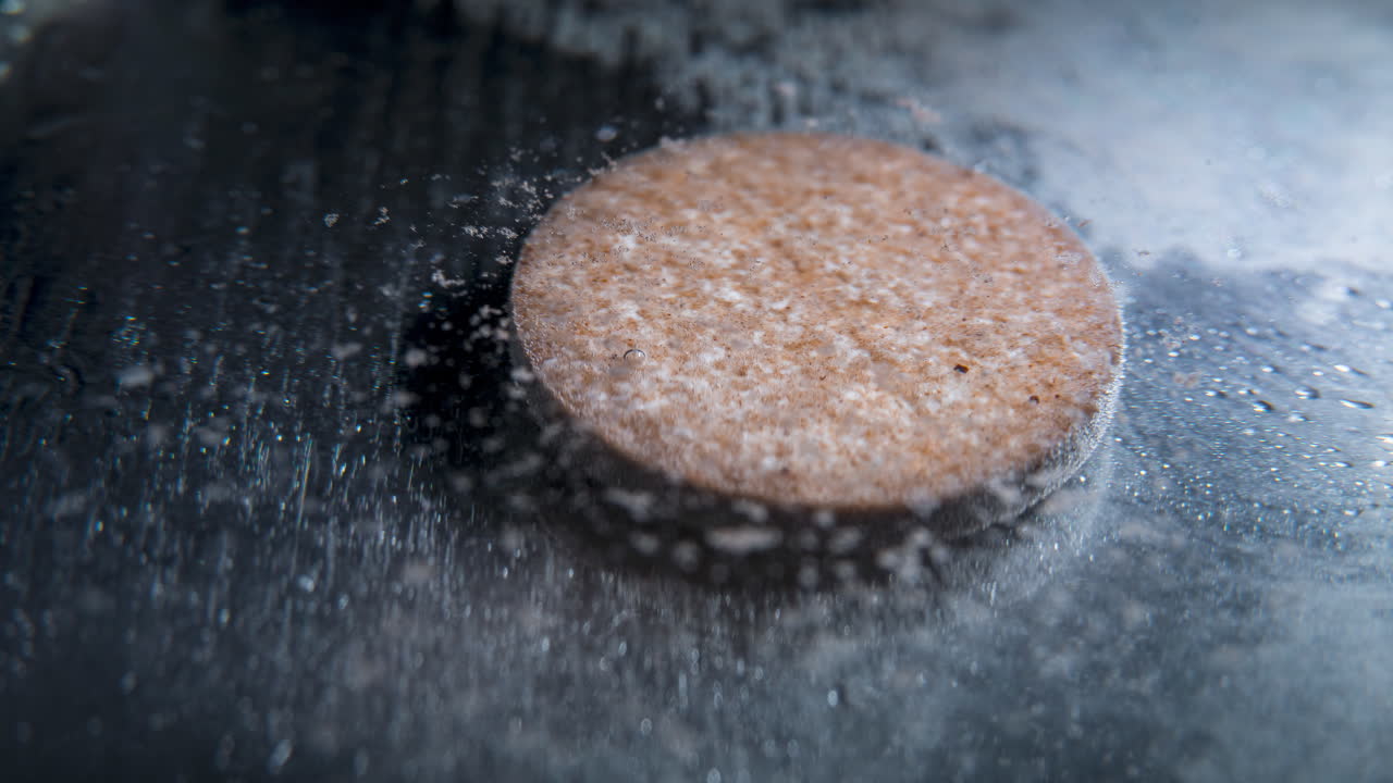 Dissolving pill in water, time-lapse of a round tablet dissolving in liquid