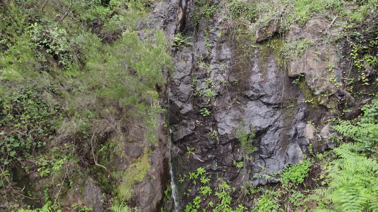 Aerial view overlooking Cascata do Chilr&atilde;o rocky waterfall slope in Monchique, Portugal lush surrounding wilderness
