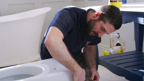 plumber cleaning new toilet basin before fitting