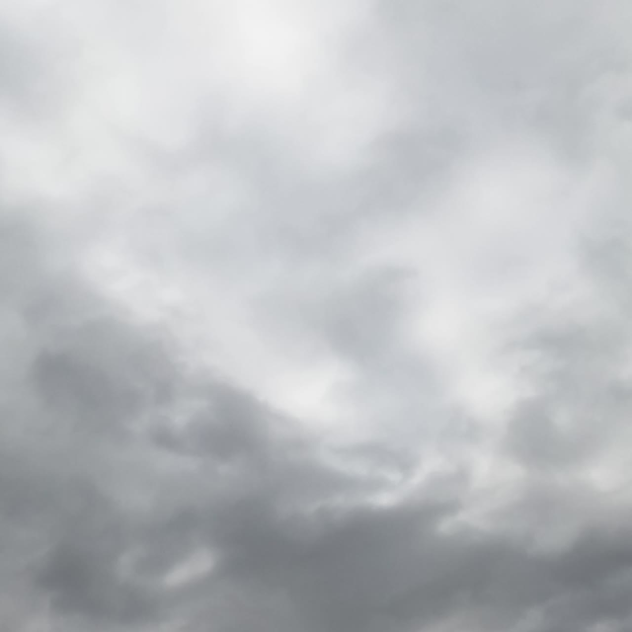 Skies can't be seen because of grey cloudscape coating the horizon. Low angle view. Timelapse