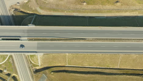 aerial view of vehicles on an overpass with intersecting roads below