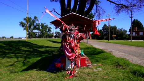 a shrine in honor of gauchito gil near a provincial route