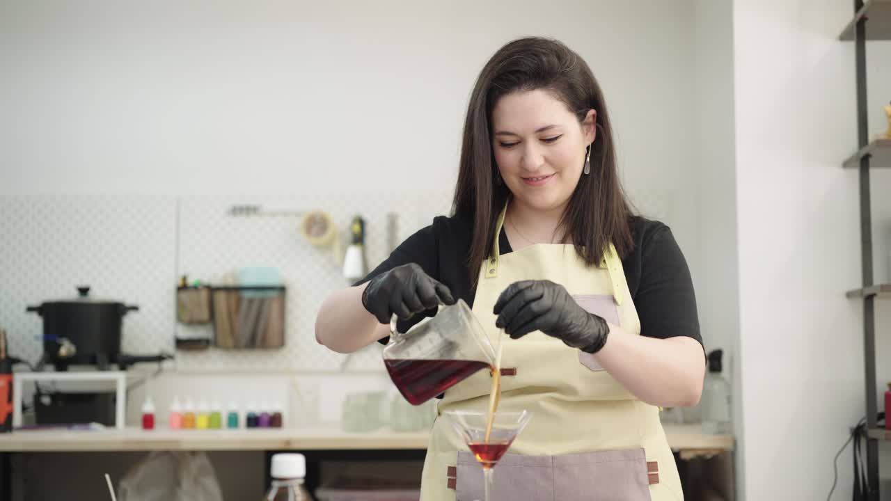 Woman pouring liquid into a martini glass for crafting