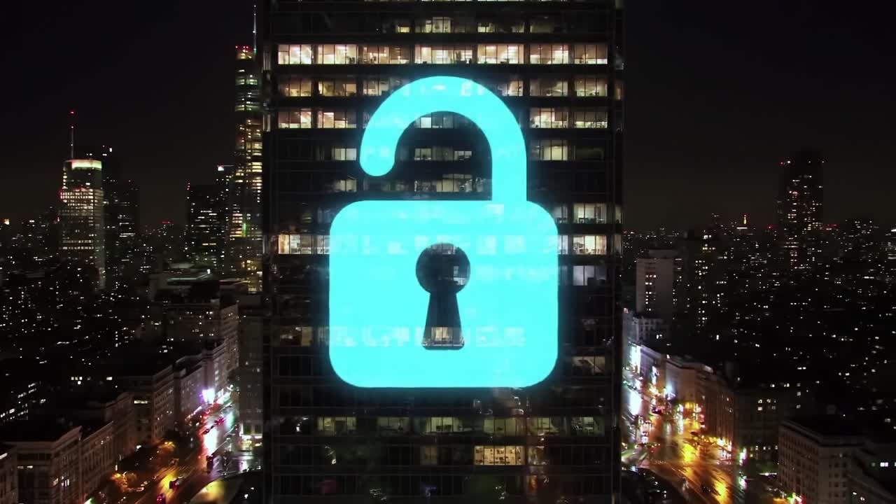 Illuminated Lock Icon Transitioning from Secured to Unsecured Displayed on Skyscraper at Night, Signifying Digital Security Concepts and Urban Atmosphere