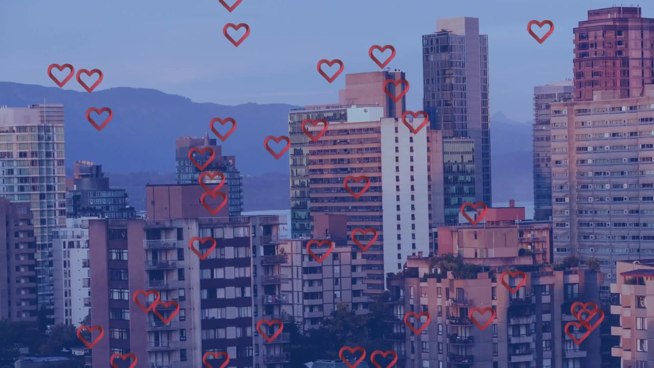 Animação de múltiplos ícones de coração vermelho flutuando sobre uma vista aérea de edifícios altos.